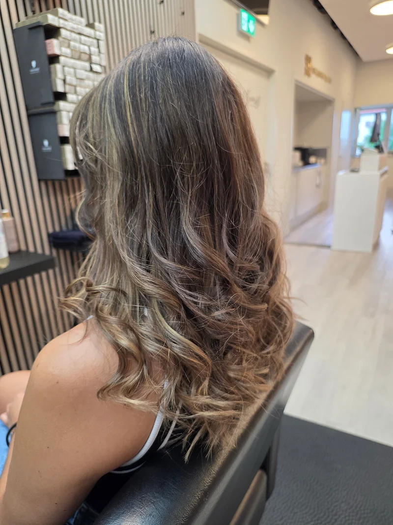 Braunes Haar mit warmen Karamell-Akzenten und weichen Wellen im Beautycenter by Neta St. Gallen